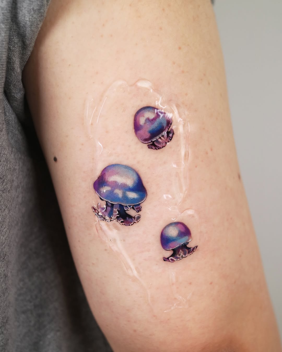 Vibrant jellyfish tattoos with a watercolor style Tattoo on skin