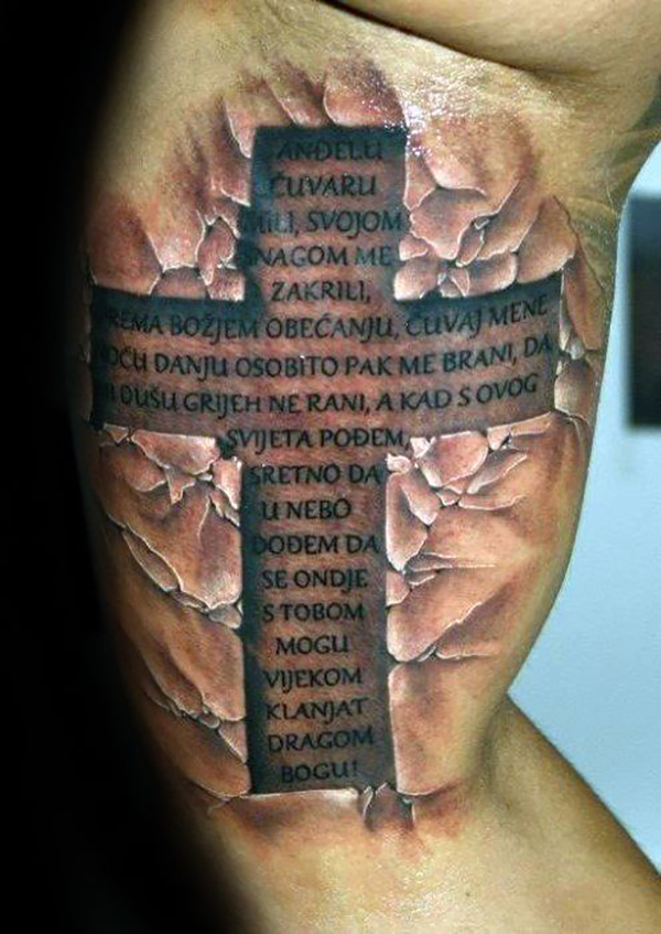 Andelu Cuvaru Cross Tattoo with Broken Rock Background Tattoo on skin