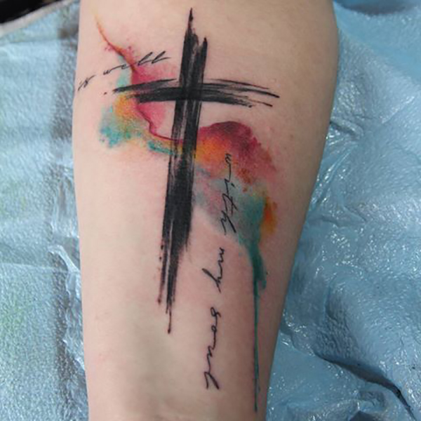 Artsy Paint Stroke Cross Tattoo with Watercolor Background Tattoo on skin