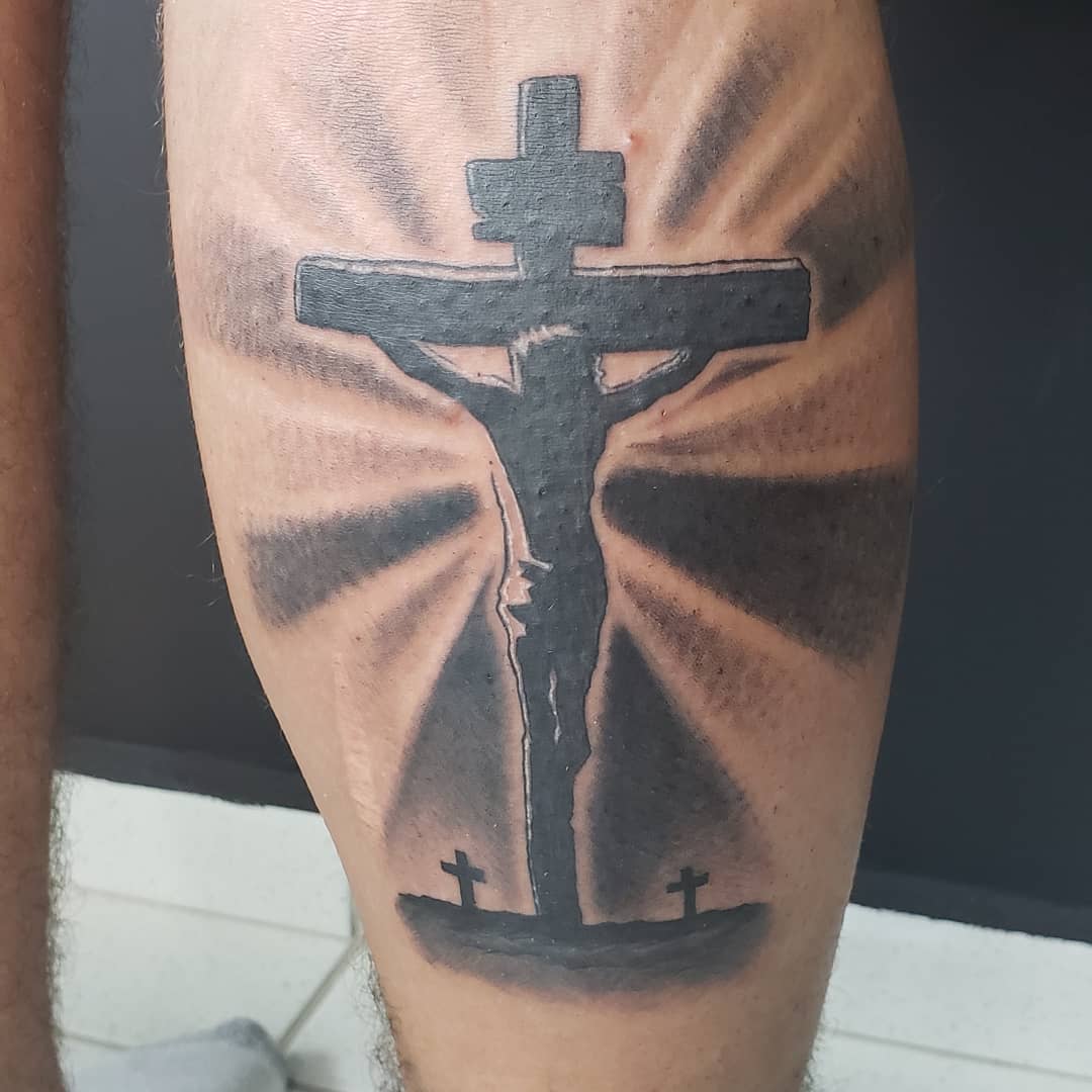 Silhouette of Jesus on the Cross Tattoo on Calvary Hill Tattoo on skin