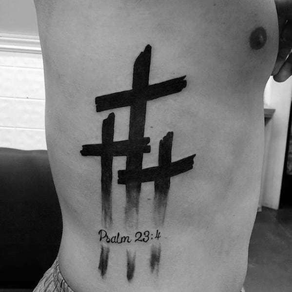 Slanted Crosses at Calvary with a Bible Verse Cross Tattoo Tattoo on skin