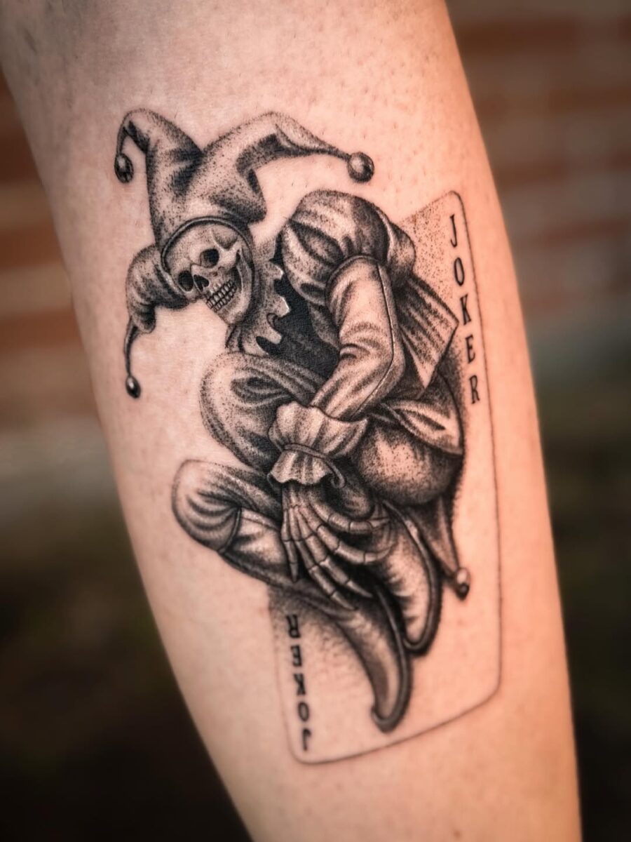 Intricate Joker Tattoo Design with Skull Tattoo on skin