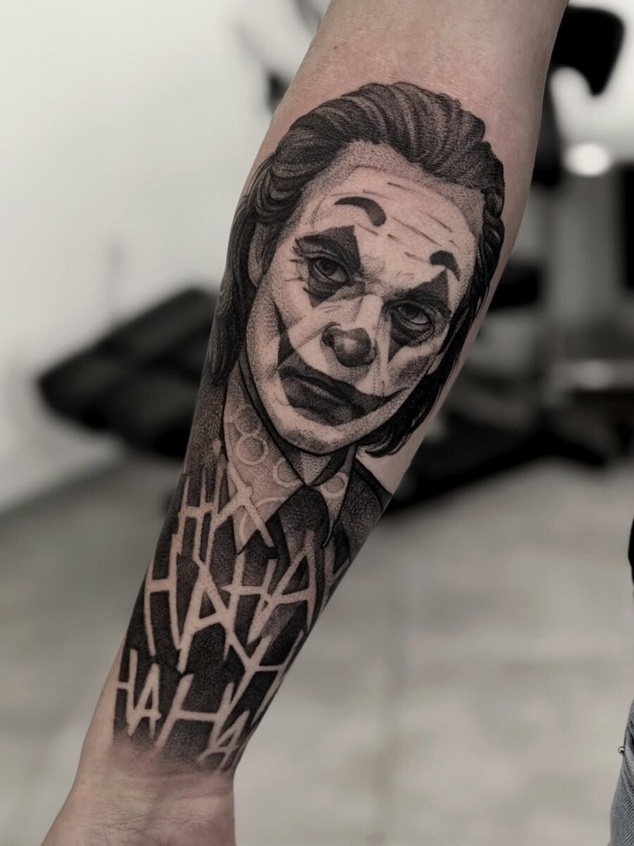 Intricate Joker Tattoo with Ha Ha Background Tattoo on skin