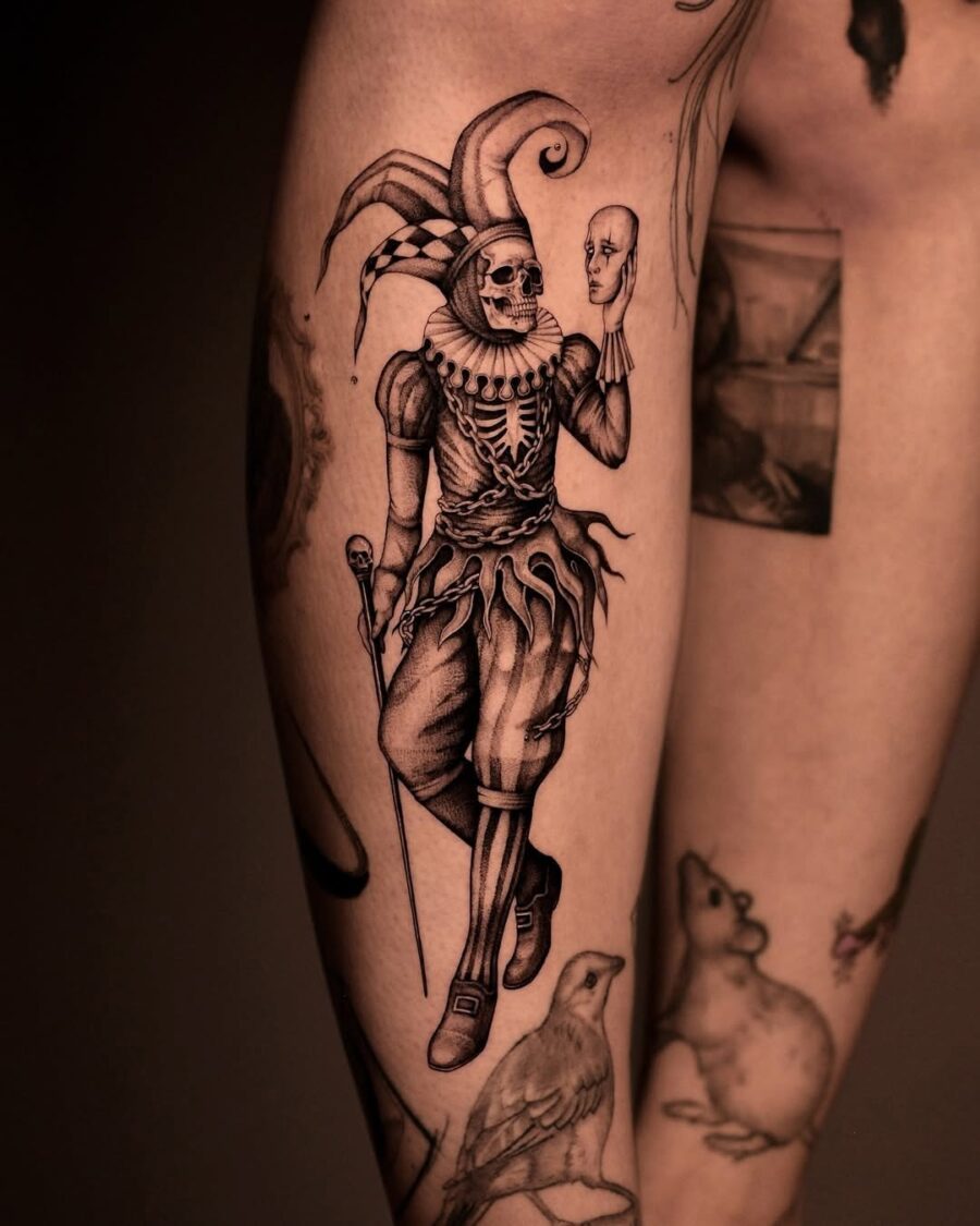 Intricate skeleton clown tattoo design on leg Tattoo on skin