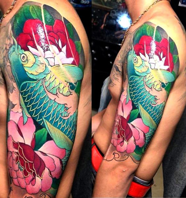 Blue Koi Fish Swimming Upstream with Lotus Koi Fish Tattoos Tattoo on skin
