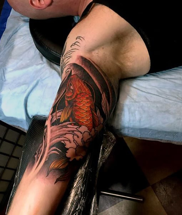 Golden Koi Fighting the Current Fish Tattoos Tattoo on skin