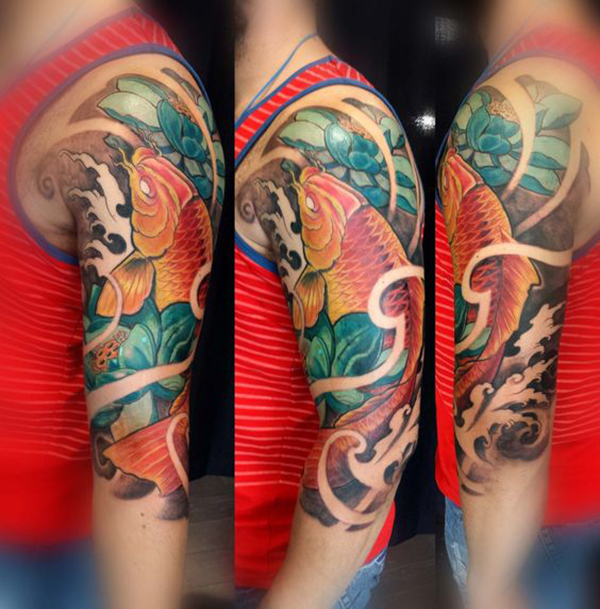Golden Koi Swimming Upstream with Lotus Koi Fish Tattoos Tattoo on skin