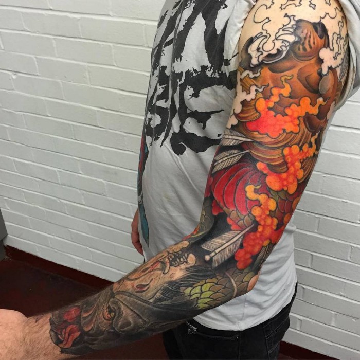 Red Koi with Arrows and Mask Tattoo on skin