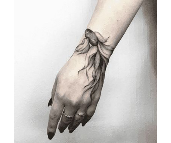 Small Monochrome Goldfish on Wrist Tattoo on skin