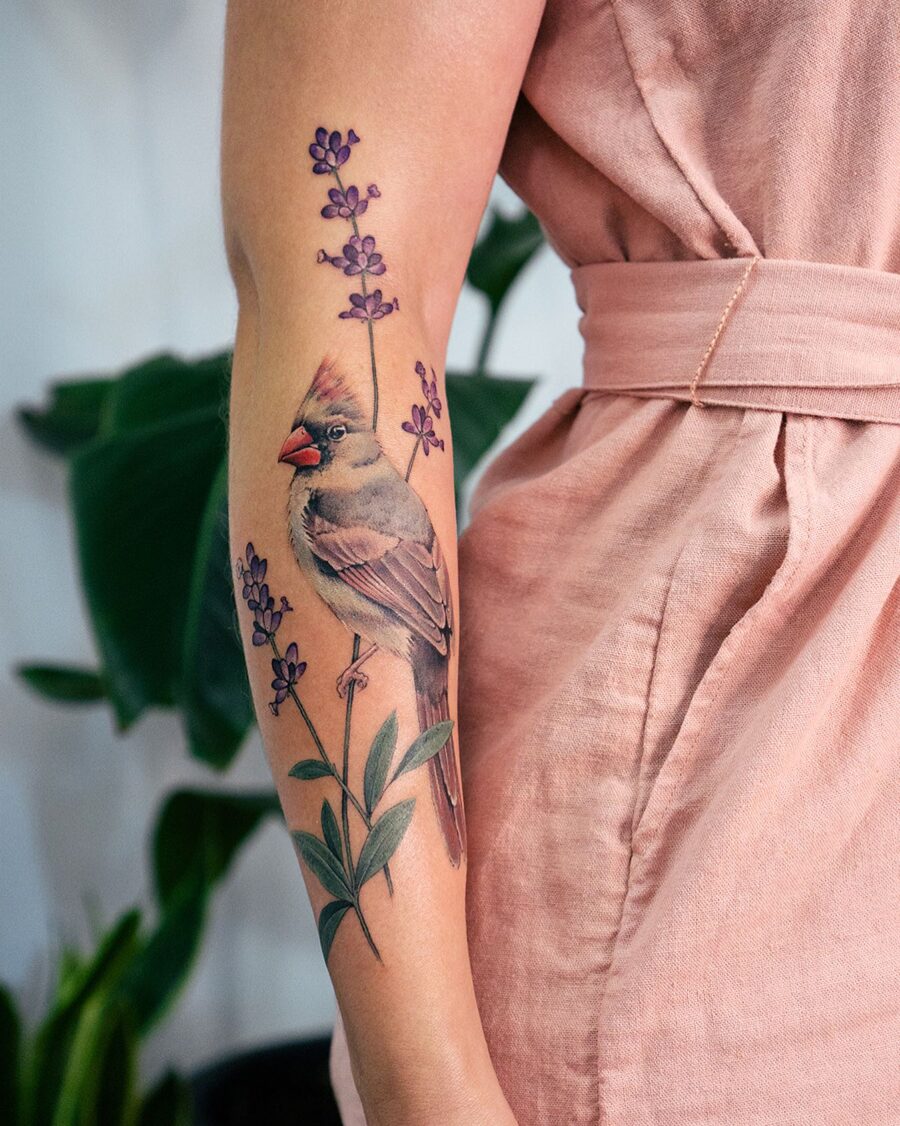 A charming bird among delicate lavender flowers Tattoo on skin