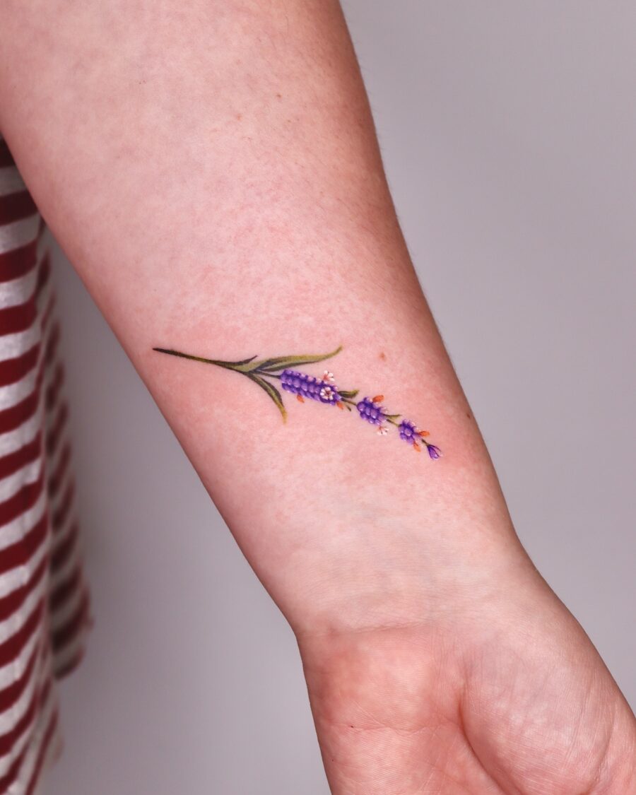 Delicate lavender tattoo design on forearm Tattoo on skin
