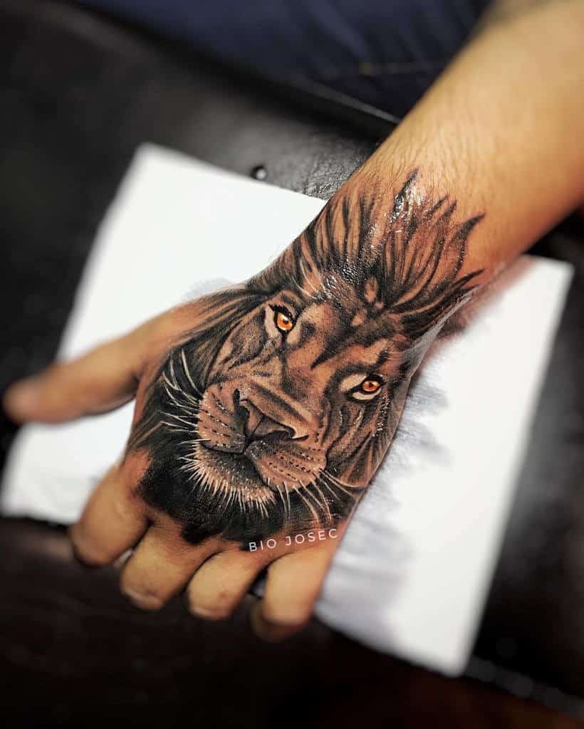 Golden Eyed Lion Tattoo on Hand Tattoo on skin