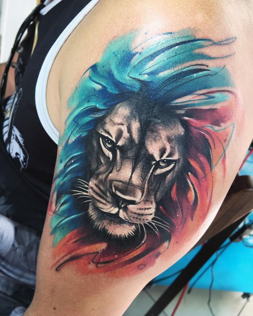 Lion Tattoo Ideas: Black, Blue, and Red Lion Tattoo Tattoo on skin