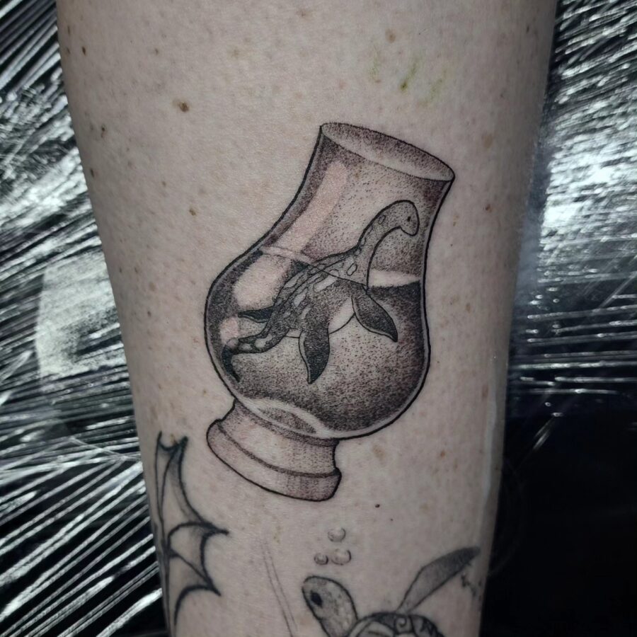 Charming Loch Ness Monster in a Glass Design Tattoo on skin
