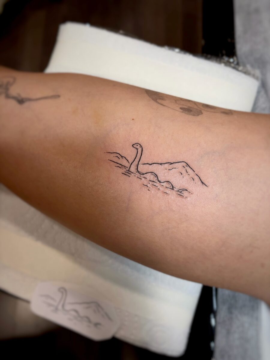 Charming minimalist Loch Ness Monster tattoo Tattoo on skin