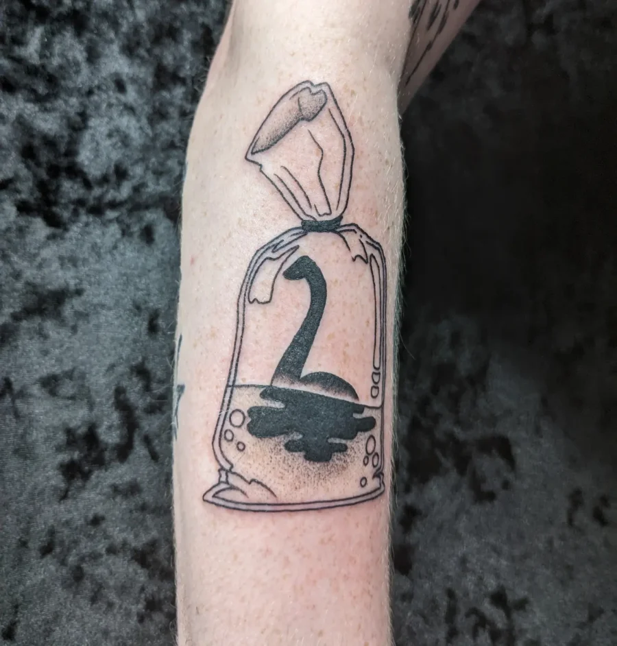 Unique Loch Ness Monster in a Bag Tattoo Tattoo on skin