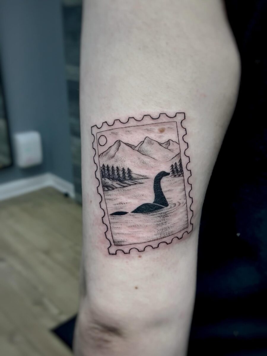 Unique Loch Ness Tattoo in a Stamp Design Tattoo on skin