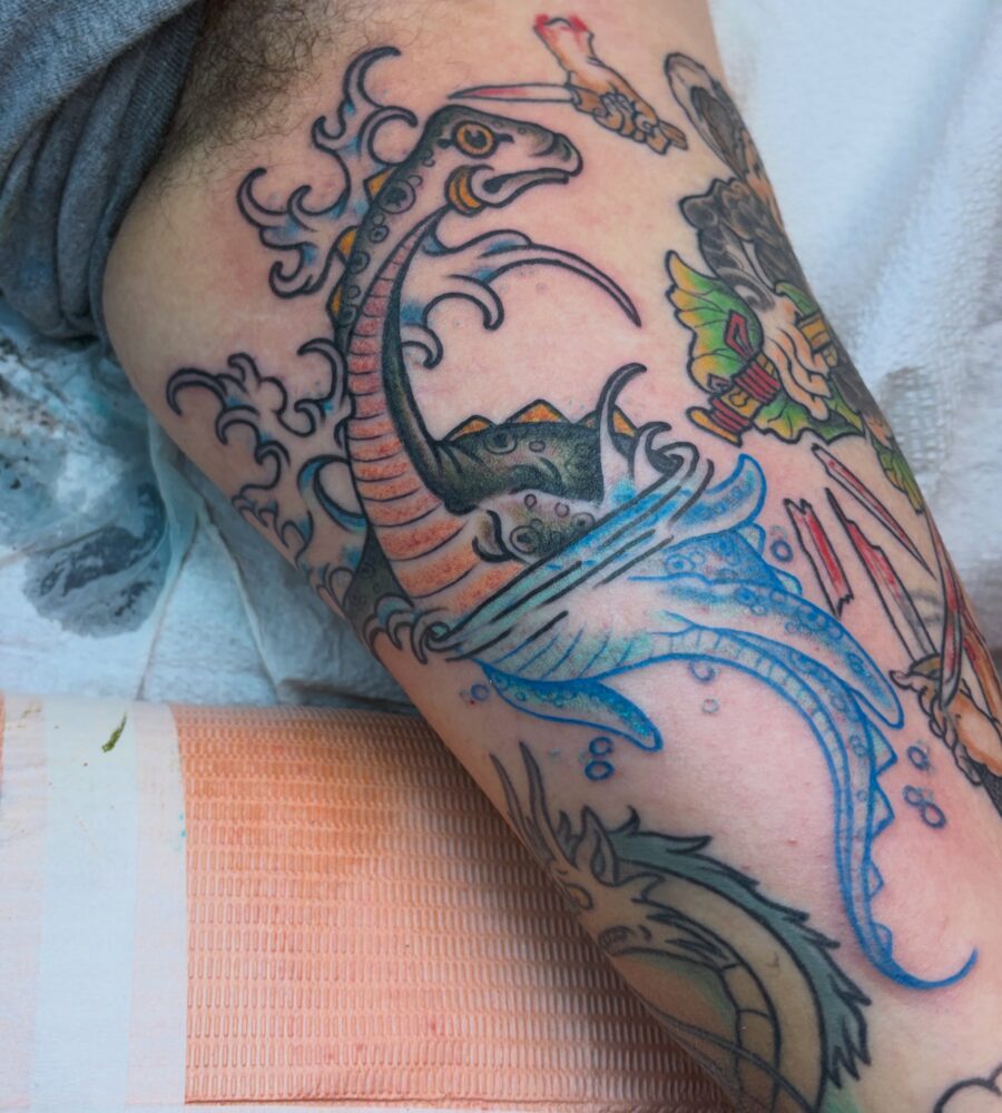 Vibrant Loch Ness Monster Tattoo in Motion Tattoo on skin