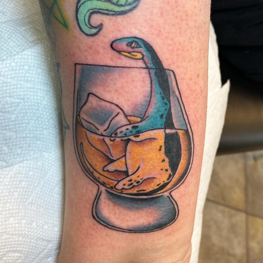 Whimsical Loch Ness Monster Tattoo in Glass Tattoo on skin