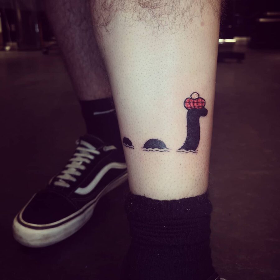 Whimsical Loch Ness Monster Tattoo with a Twist Tattoo on skin