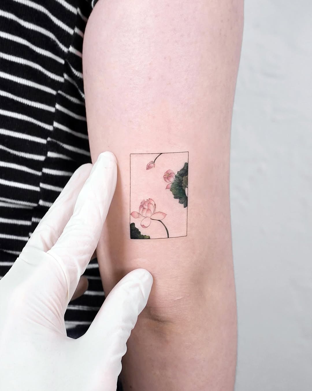 Delicate lotus tattoo design with pastel hues Tattoo on skin