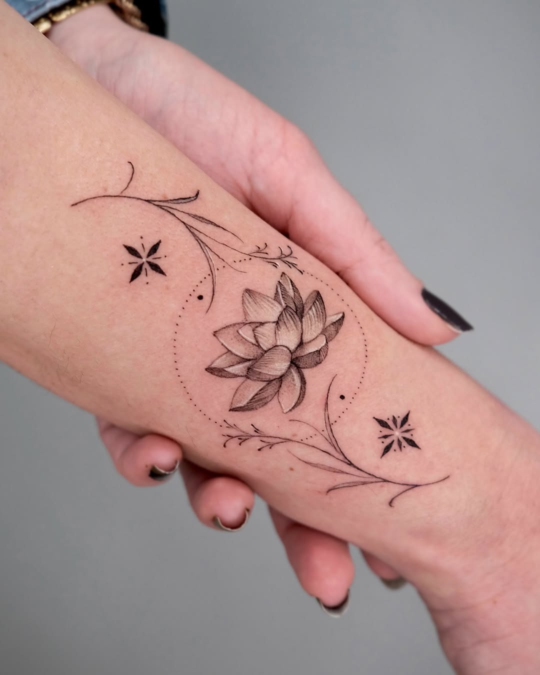 Delicate lotus tattoo with elegant floral accents Tattoo on skin