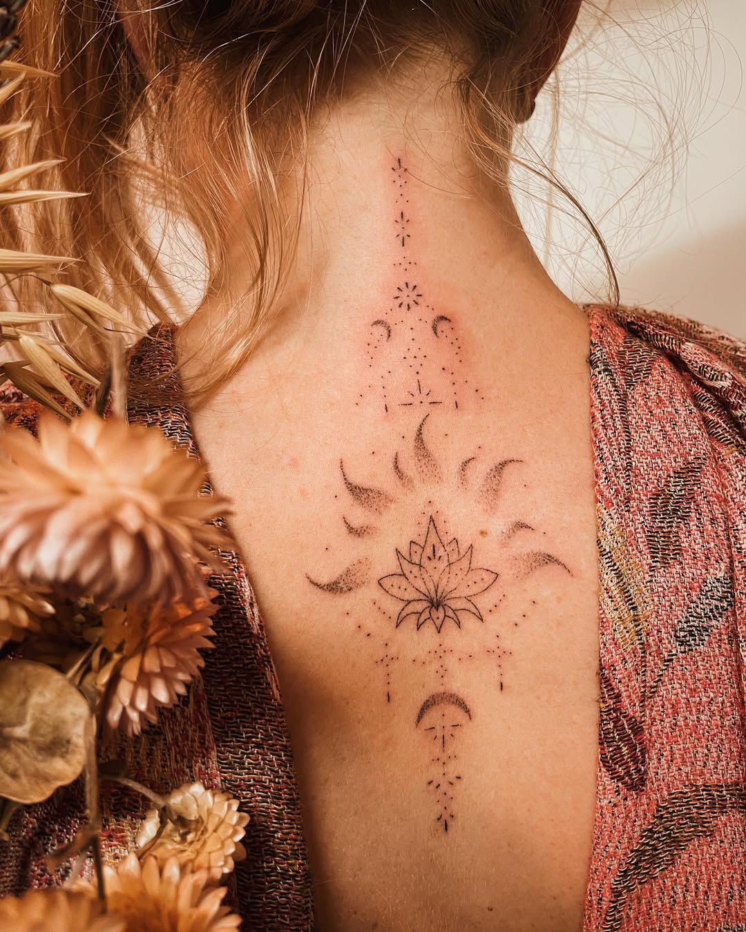 Elegant Back Lotus Tattoo With Mystical Elements lotus tattoos