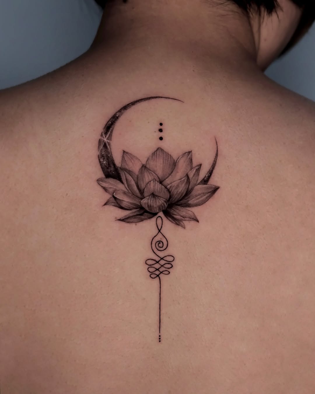 Elegant lotus tattoo with moon and line art Tattoo on skin