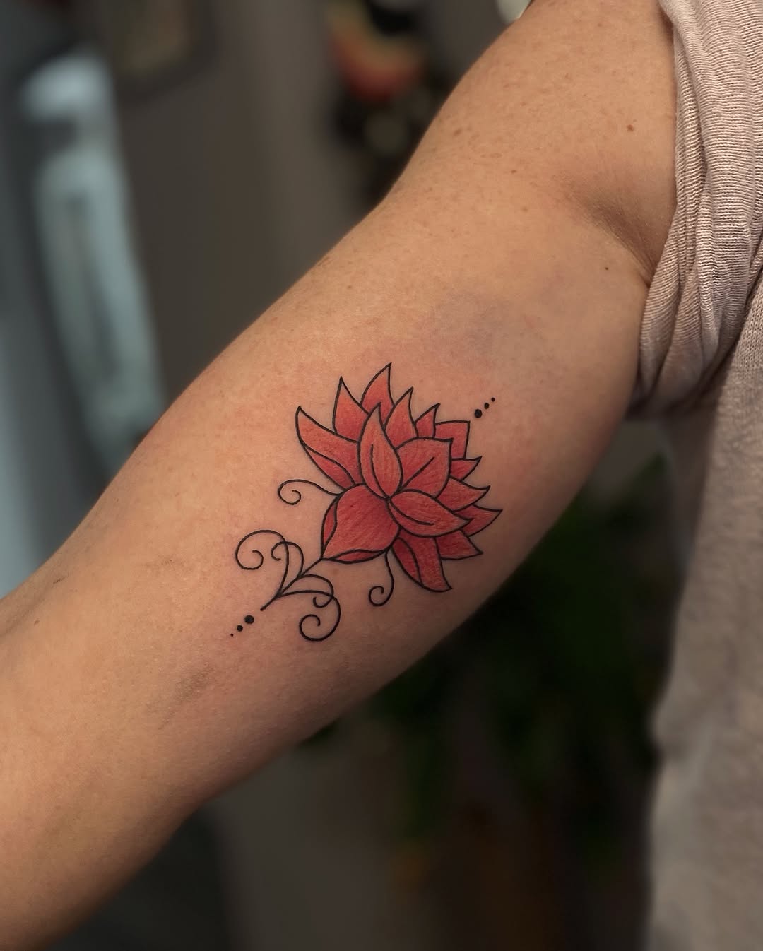 Elegant red lotus tattoo on inner bicep Tattoo on skin