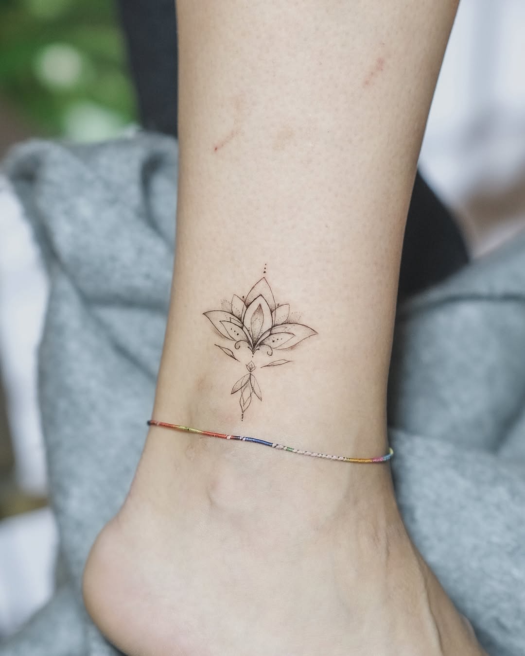 Minimalist lotus tattoo on ankle with elegance Tattoo on skin