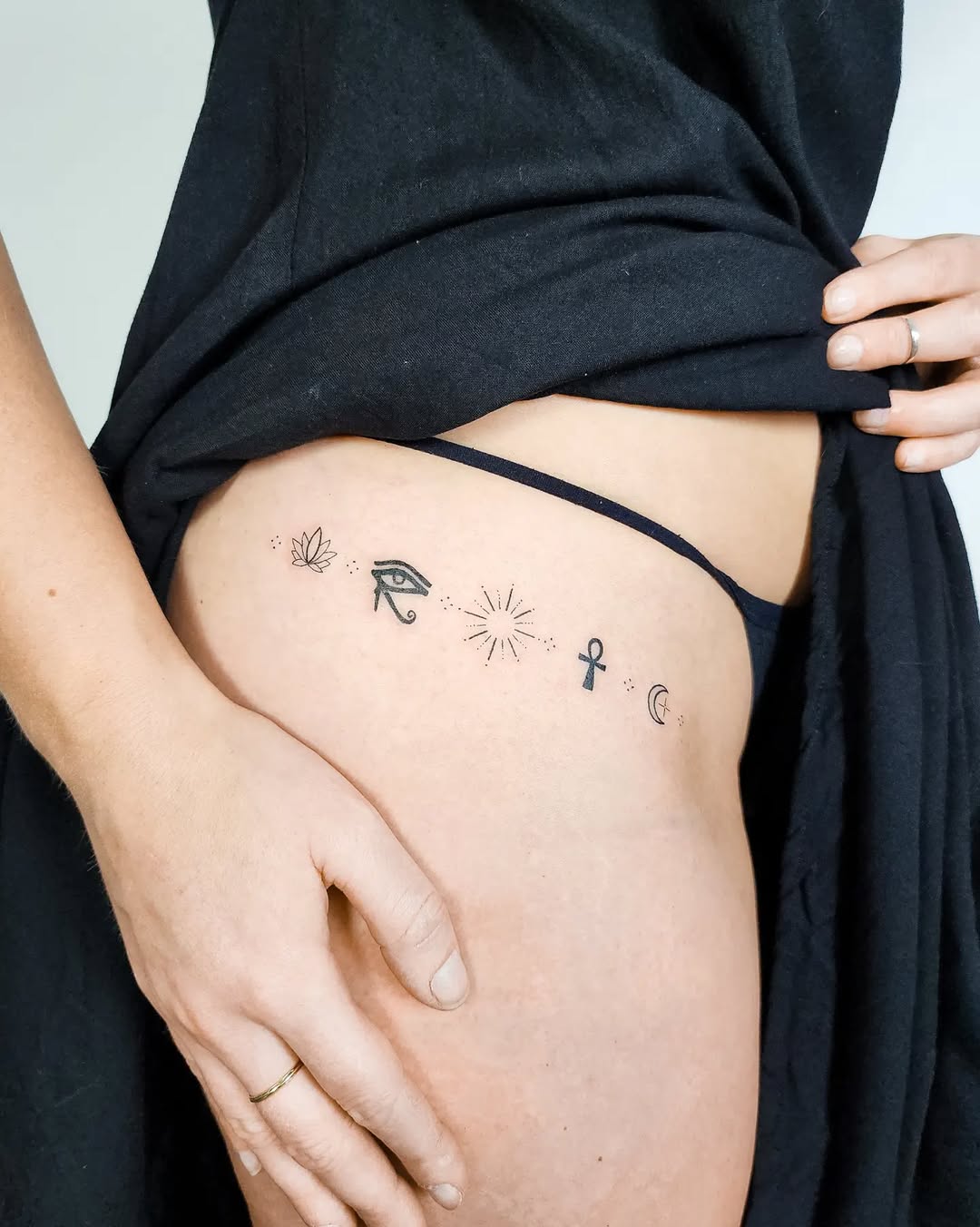 Minimalist lotus tattoo with spiritual symbols Tattoo on skin