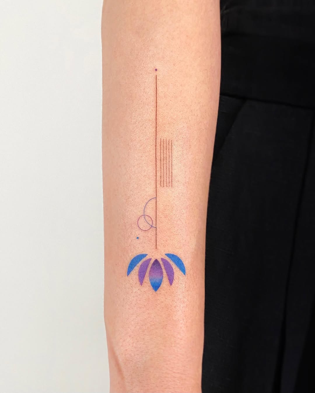 Minimalistic colorful lotus tattoo design Tattoo on skin