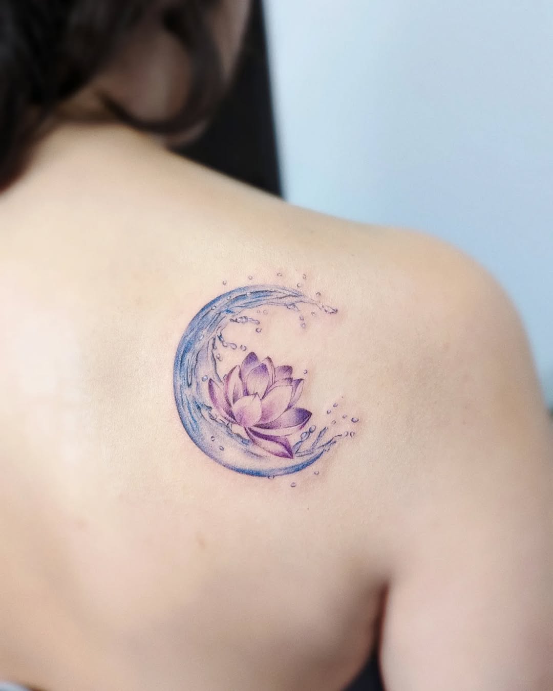 Serene lotus surrounded by flowing water design Tattoo on skin