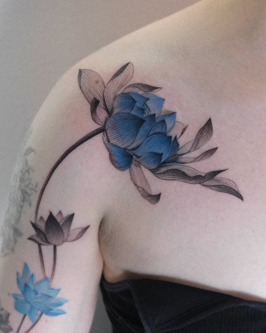 Stunning blue lotus tattoo with delicate details Tattoo on skin
