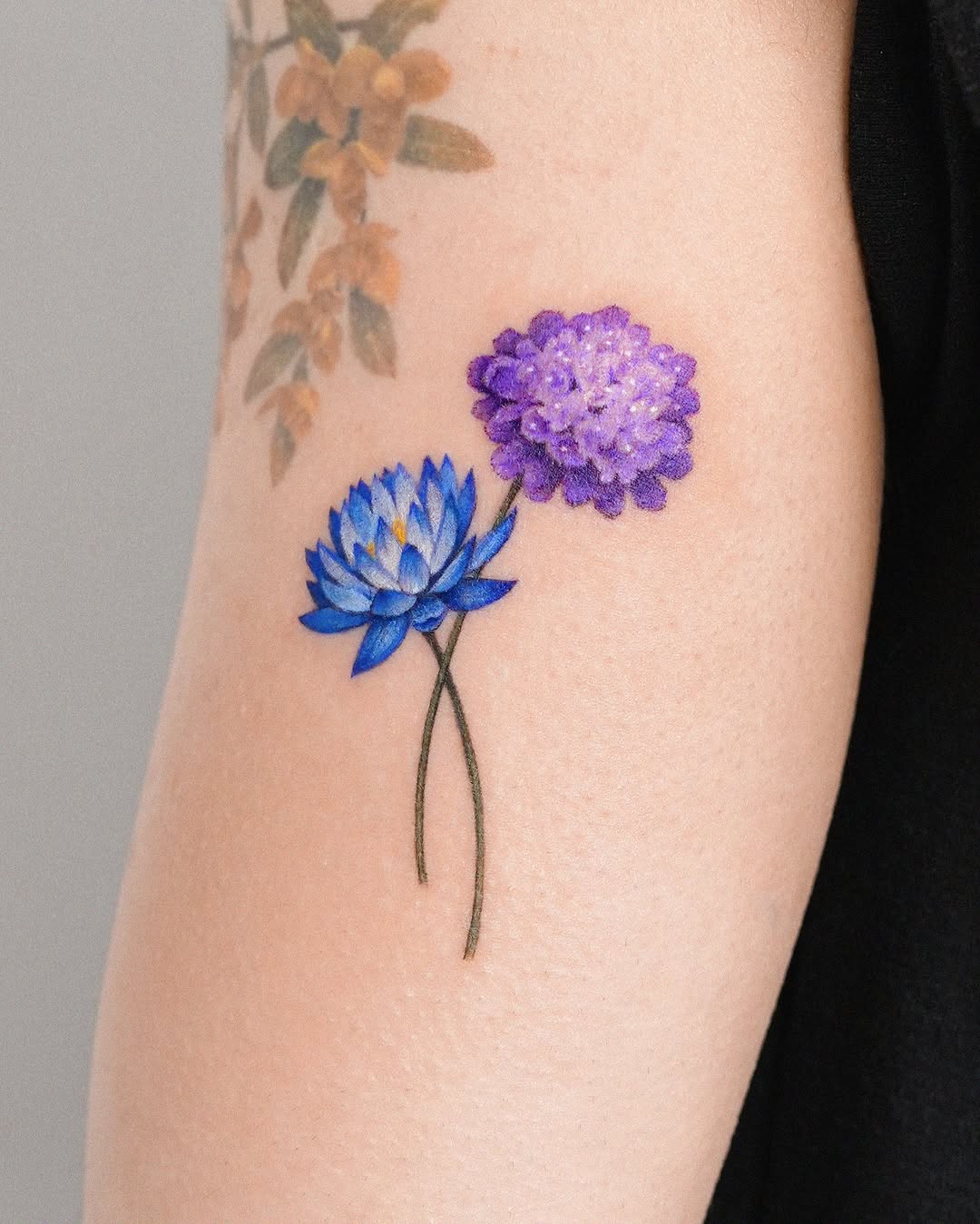 Vibrant blue and purple lotus flower tattoo Tattoo on skin