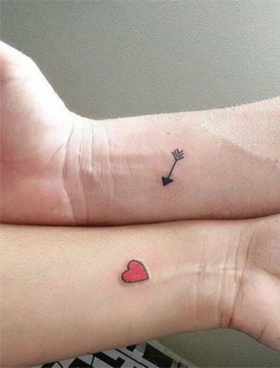 An Arrow and a Heart Love Tattoo Tattoo on skin