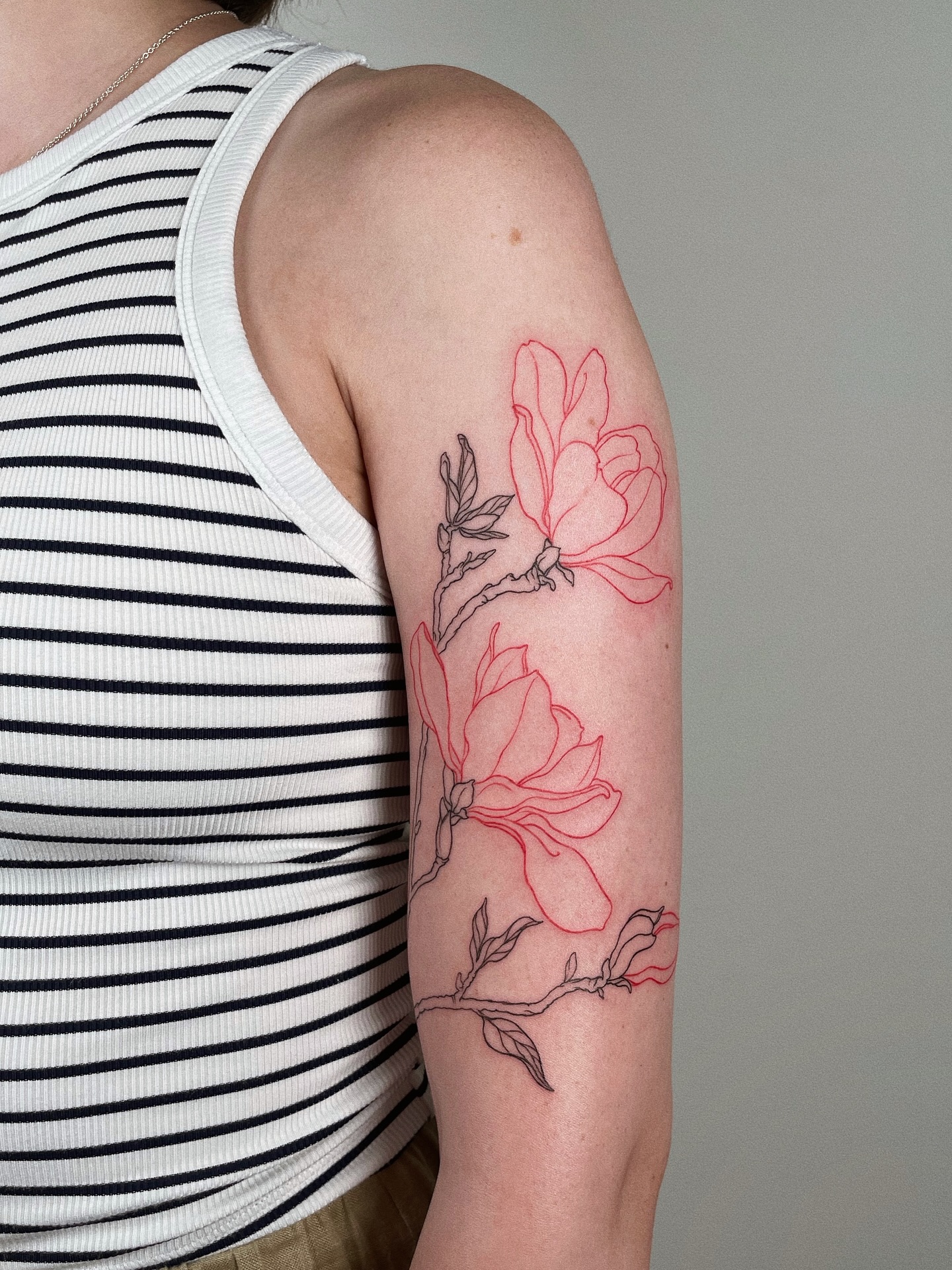Delicate outline magnolia tattoo on arm Tattoo on skin