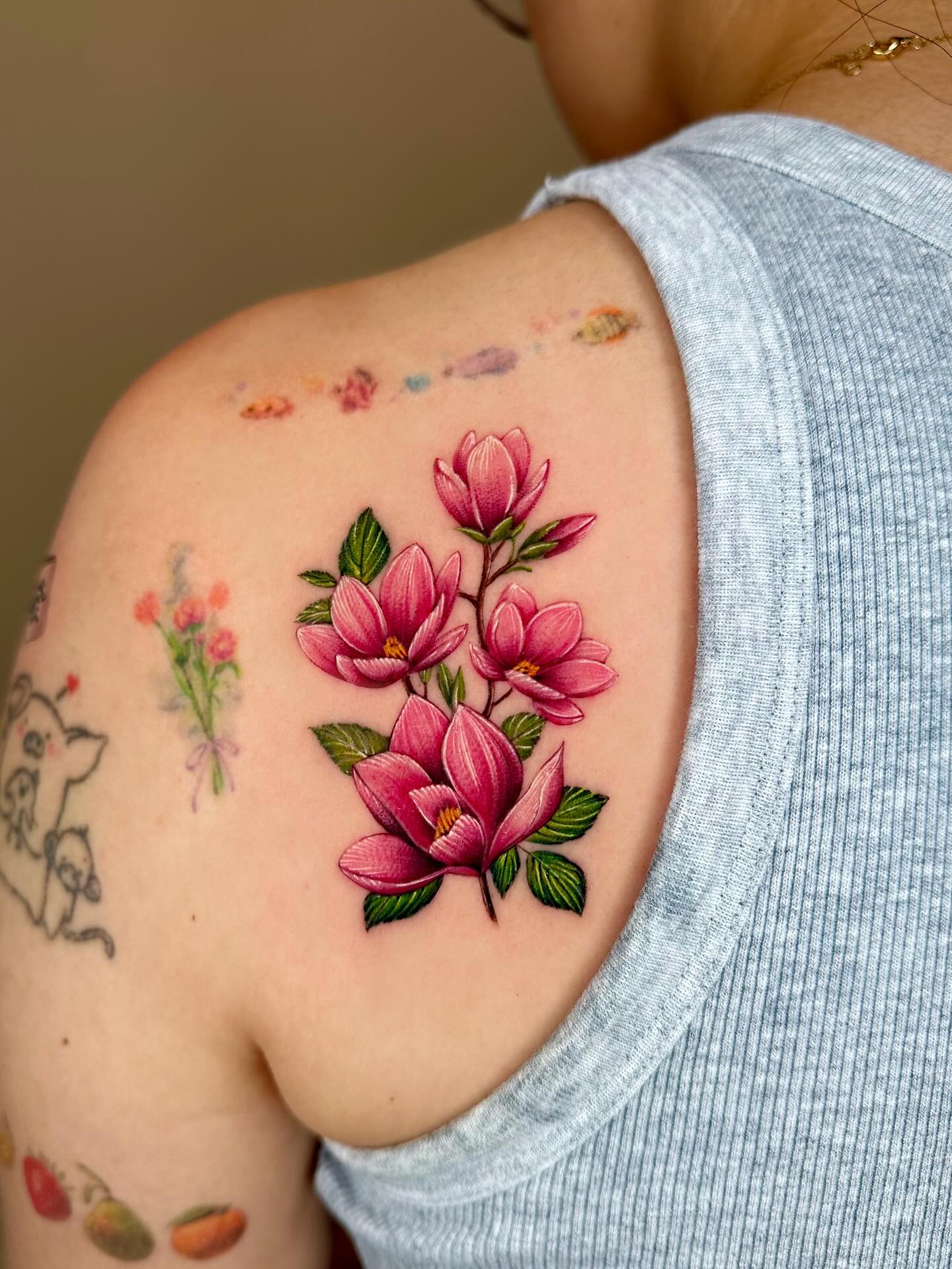 Elegant magnolia flower tattoo on the shoulder Tattoo on skin