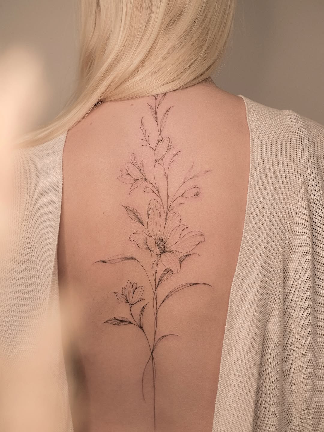 Elegant Magnolia Tattoo Captured on a Back Tattoo on skin