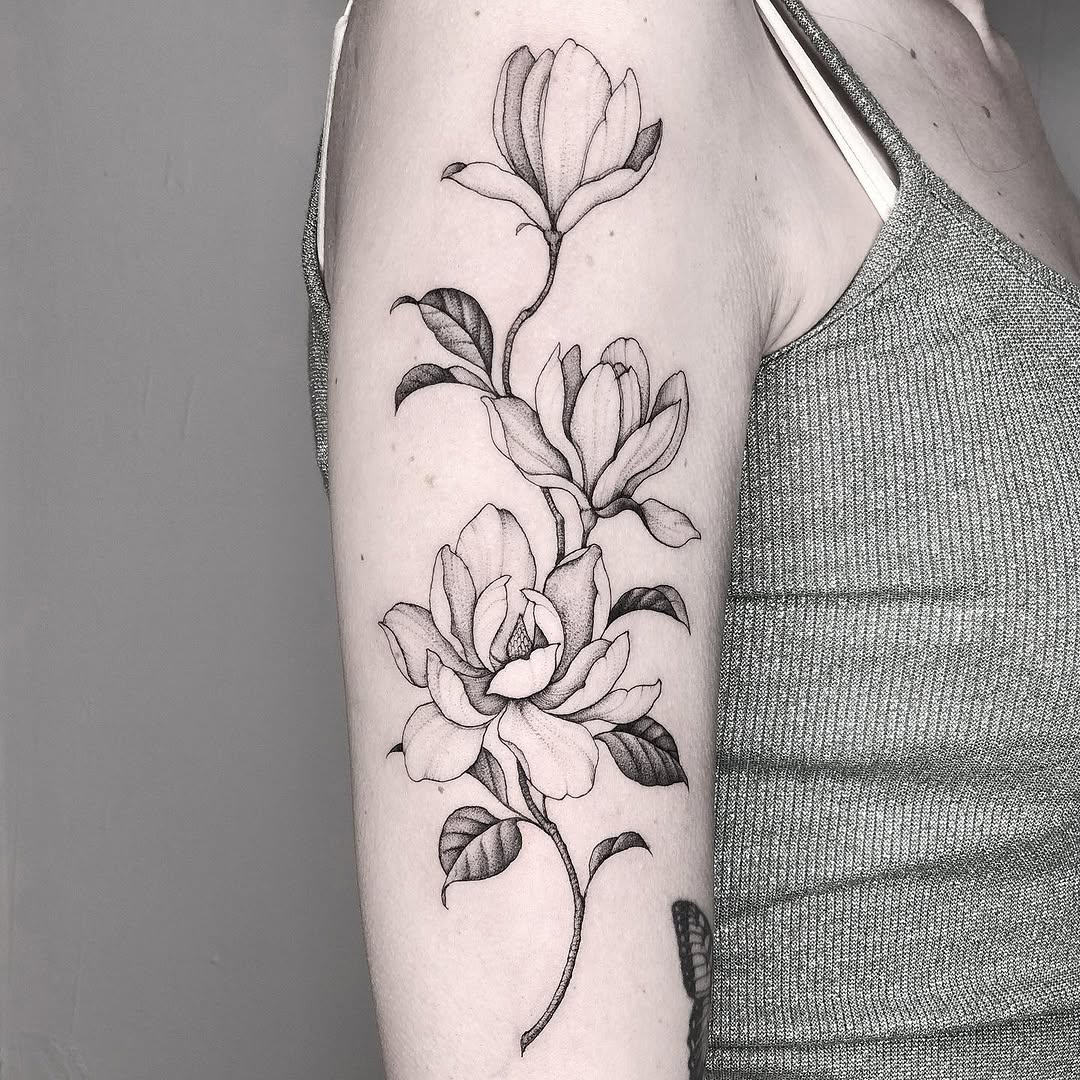 Elegant magnolia tattoo on the arm Tattoo on skin
