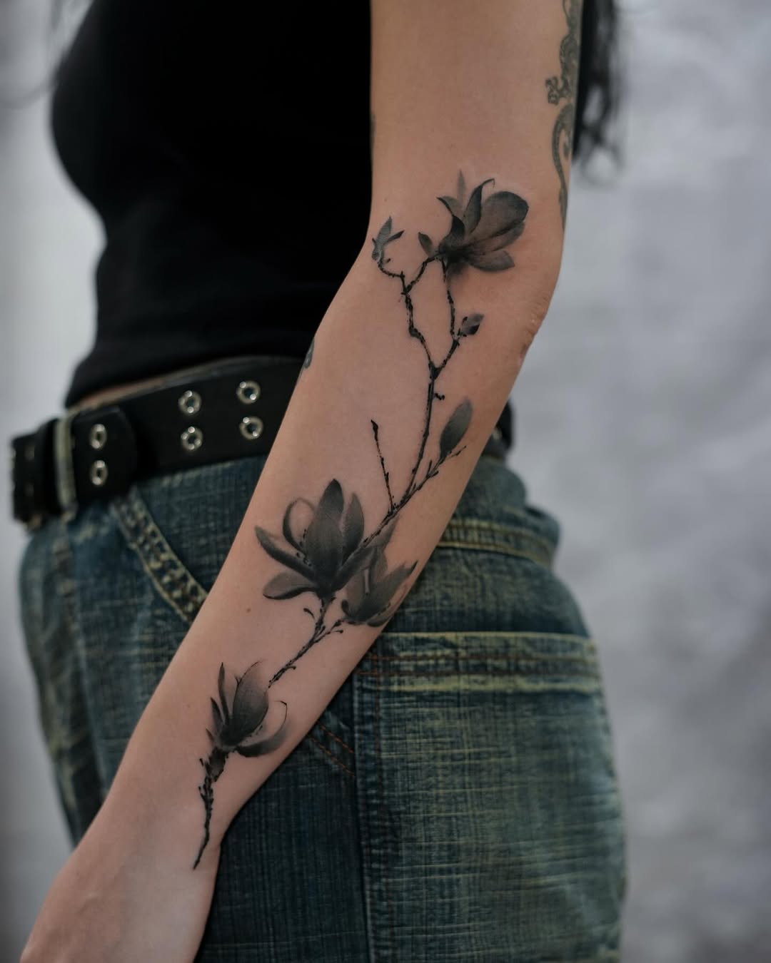 Elegant magnolia tattoo on the forearm Tattoo on skin