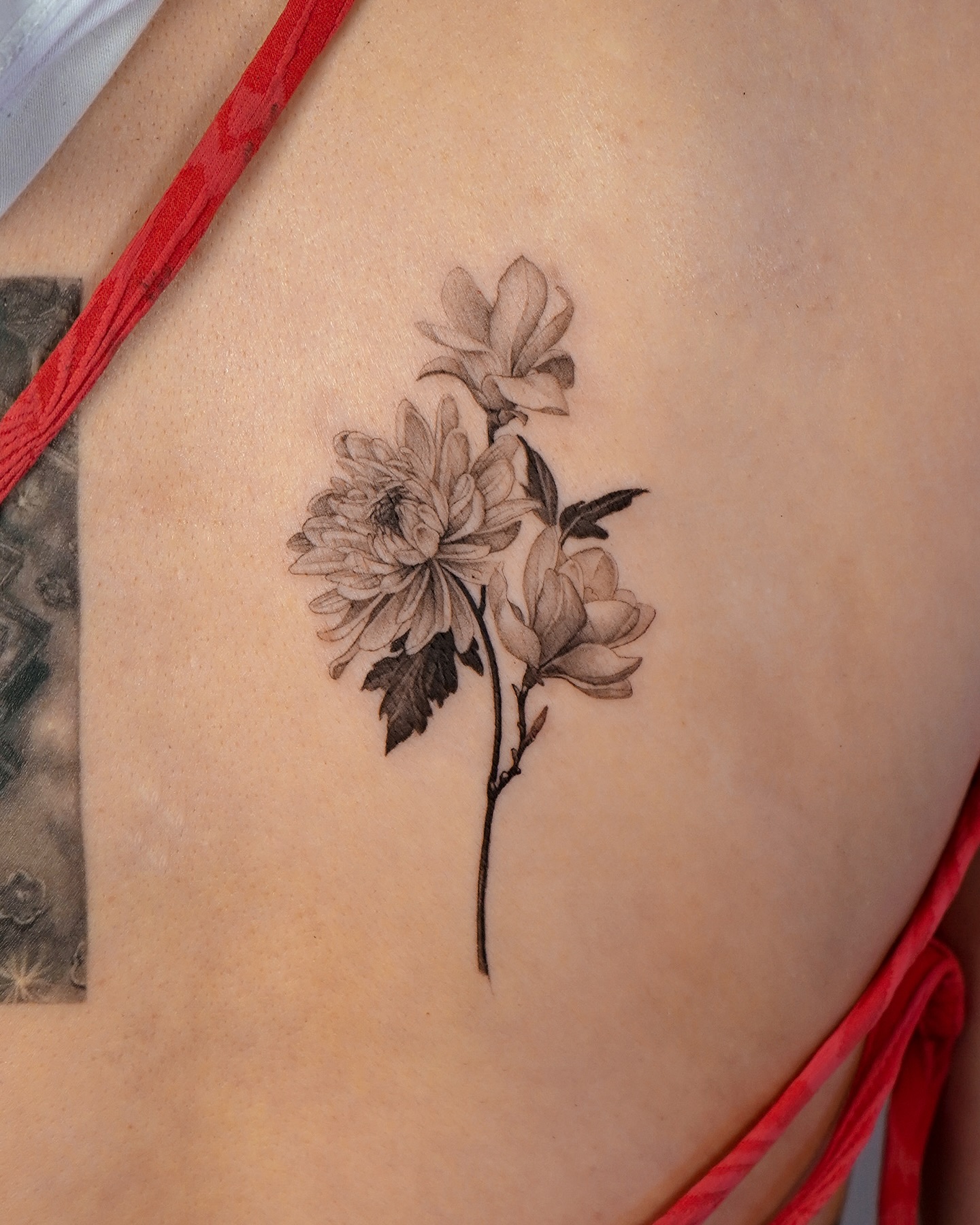 Elegant magnolia tattoo showcasing fine details Tattoo on skin