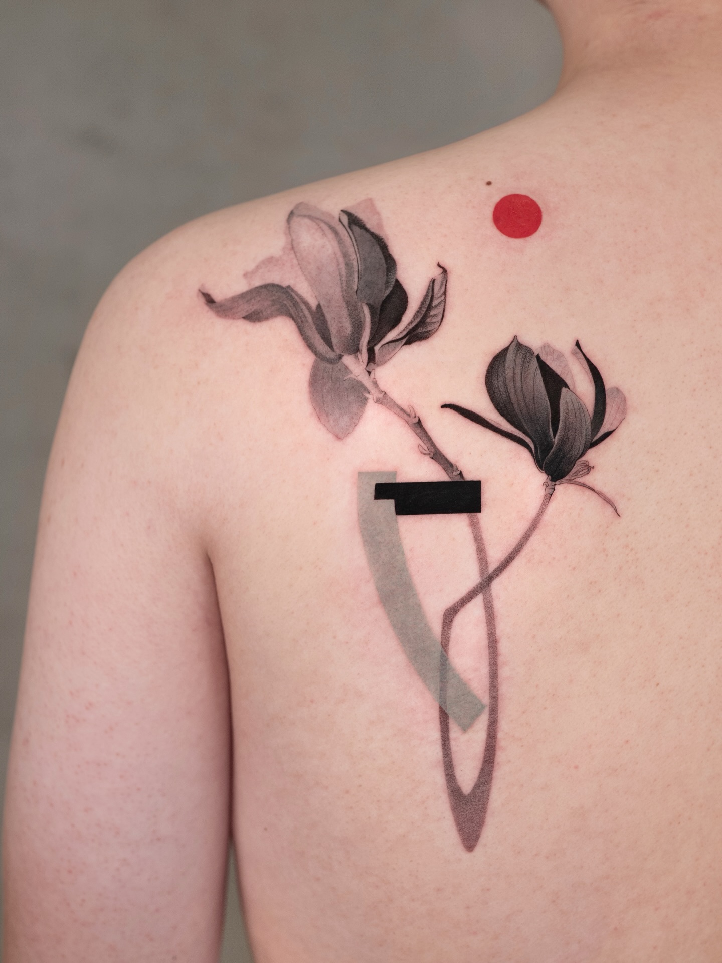 Elegant Magnolia Tattoo with Abstract Features Tattoo on skin