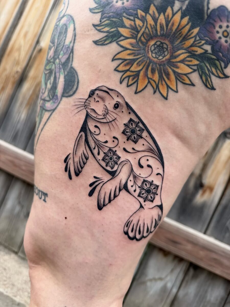 Charming Manatee Tattoo with Floral Designs Tattoo on skin