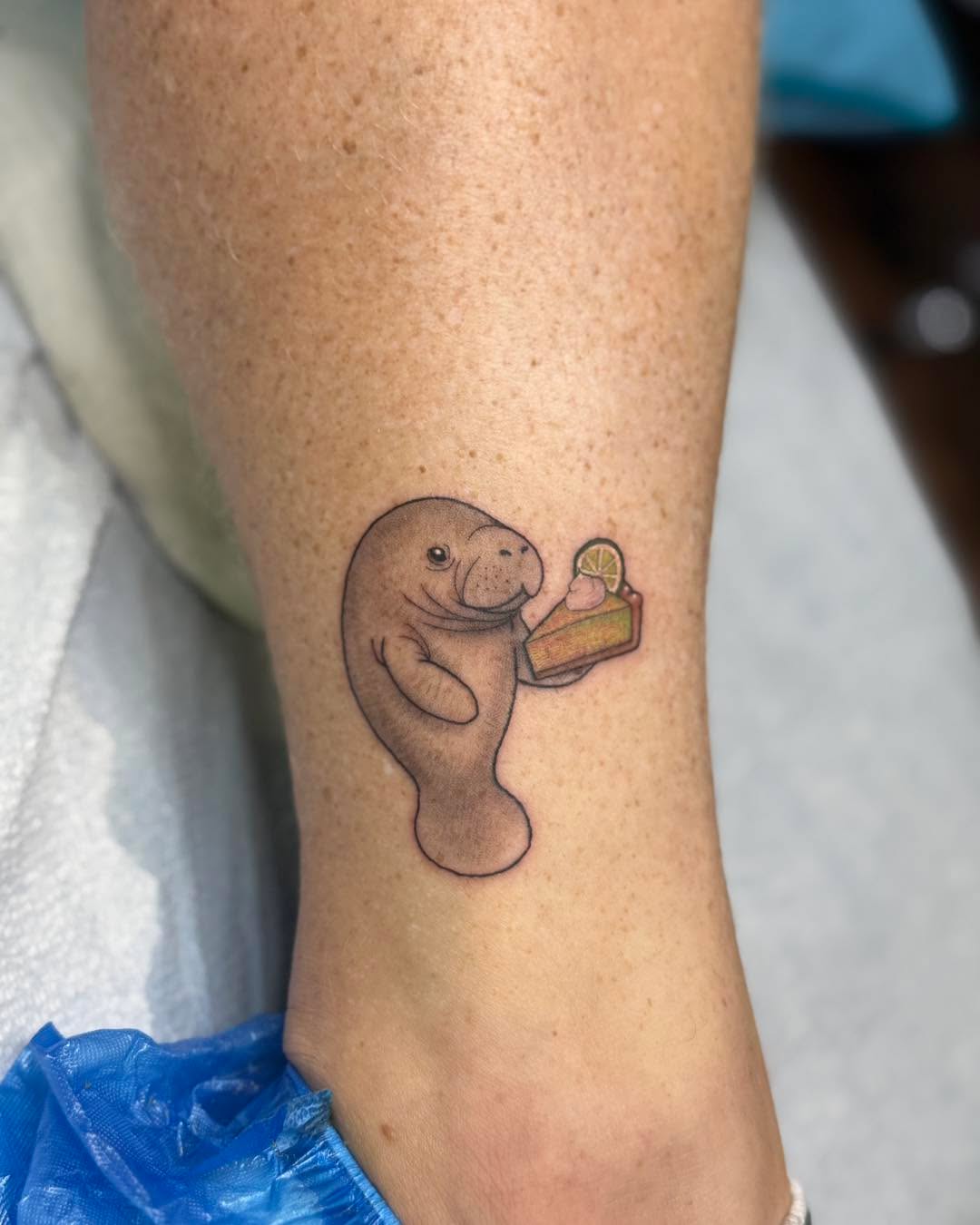 Charming Manatee Tattoo with Food Element Tattoo on skin