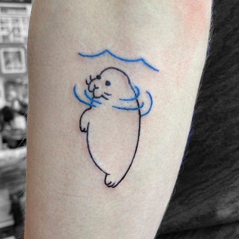 Charming Manatee Tattoo with Minimalist Design Tattoo on skin