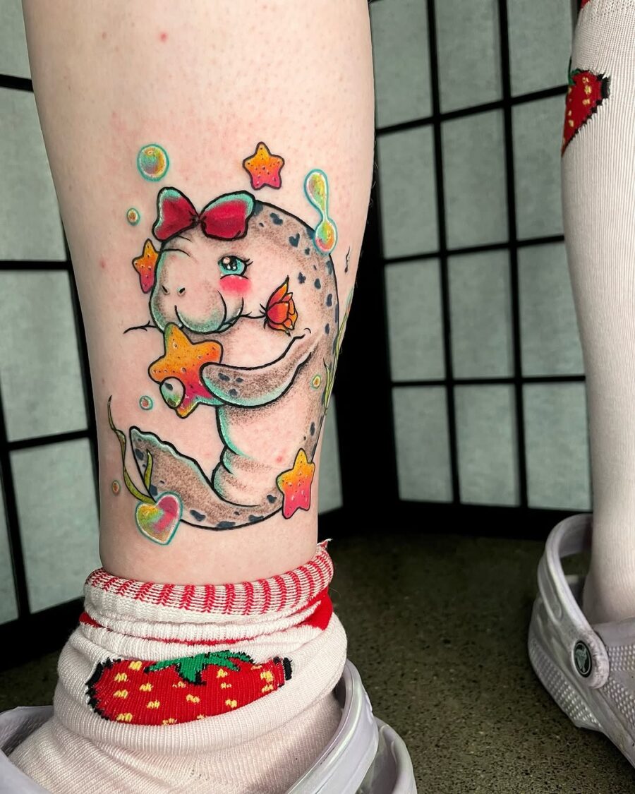 Charming manatee tattoo with playful stars Tattoo on skin