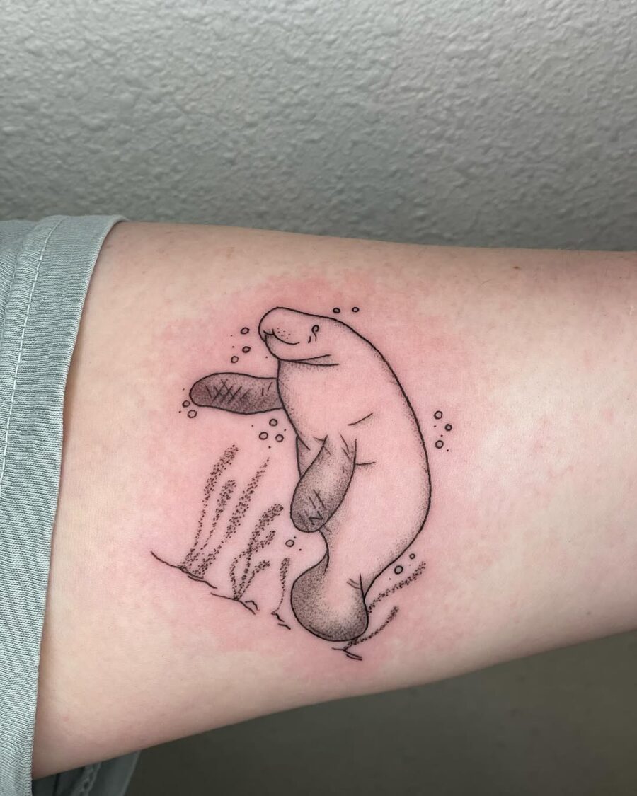 Charming Manatee Tattoo with Underwater Elements Tattoo on skin