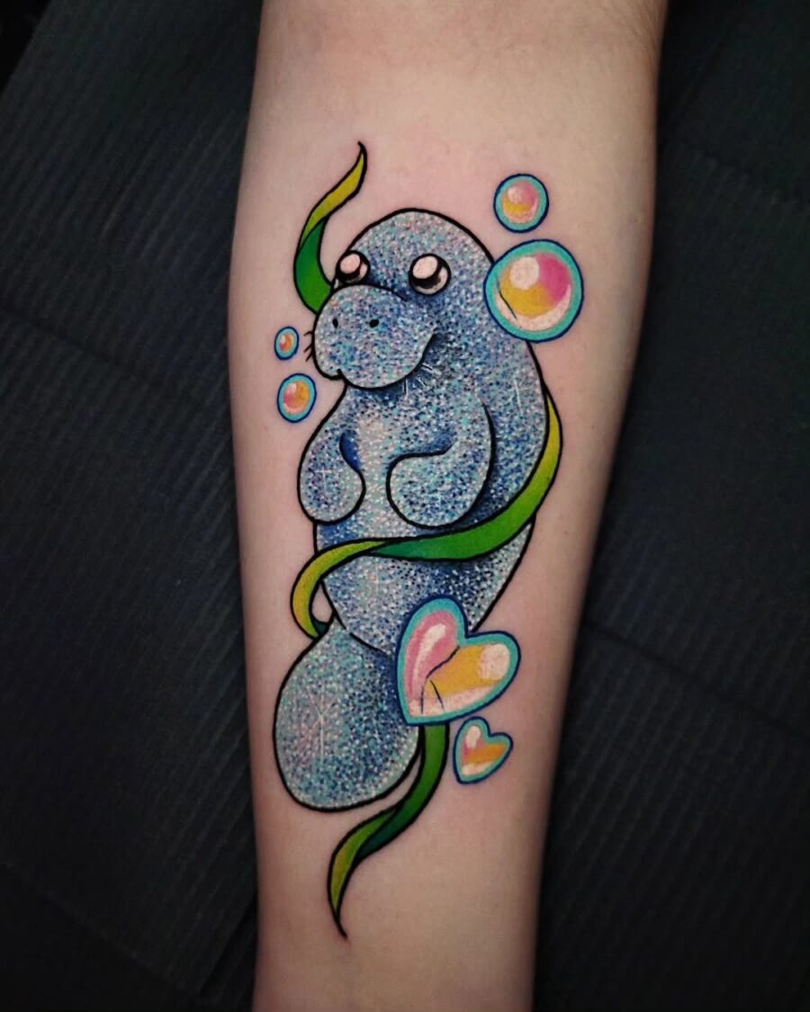 Cute manatee tattoo with vibrant bubbles and colors Tattoo on skin