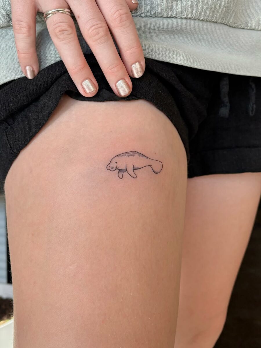 Cute minimalistic manatee tattoo on thigh Tattoo on skin